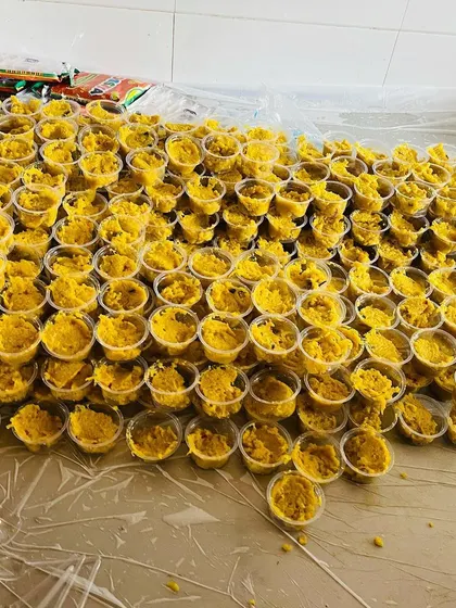 A large batch of our yellow sweet dish, portioned into individual cups. We can handle dessert orders for very large gatherings without any issue.