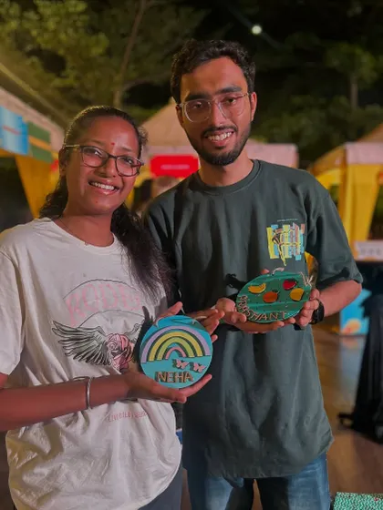A couple proudly displaying the personalized art they created at our stall. My workshops are for everyone, and it's a great activity for a creative date.