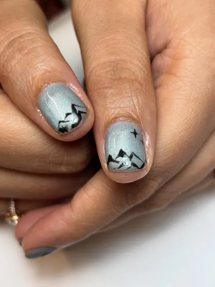 A close-up on the thumbs, featuring a beautifully detailed mountain range under a starry night sky. This design was a key part of the Swiss-themed set.