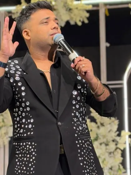 A black jacket with scattered crystal embellishments. It's a modern, glamorous look that's perfect for a high-end Sangeet or reception.