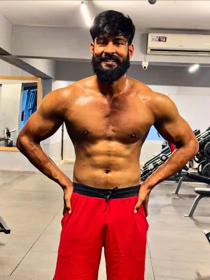 "All progress takes place outside the comfort zone." A full-body, shirtless shot after a grueling workout.