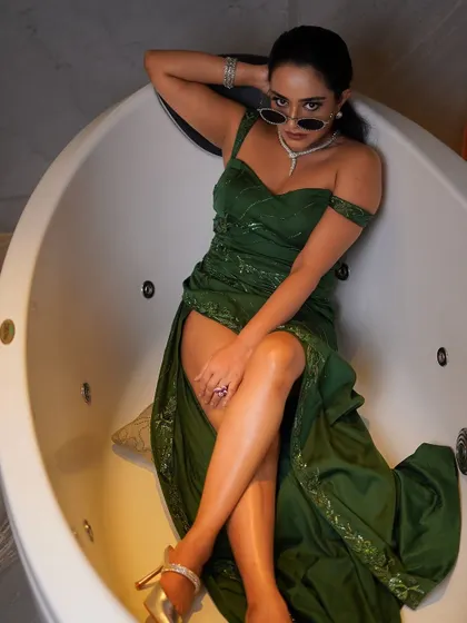 A full-body shot from a high angle, emphasizing the long lines of the legs and the dramatic slit of the gown.