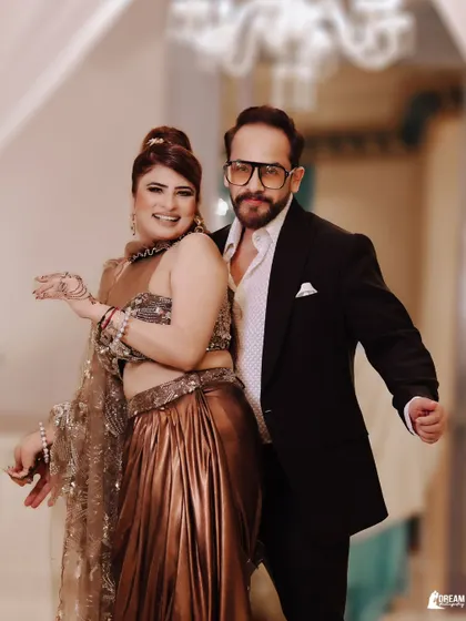 A fun and candid shot of Ajay and Kirti, their playful energy perfectly captured.