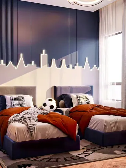 A stylish shared bedroom for two, featuring a custom LED light fixture that mimics a city skyline. The sophisticated color palette of navy blue and burnt orange makes it suitable for older children or teens.