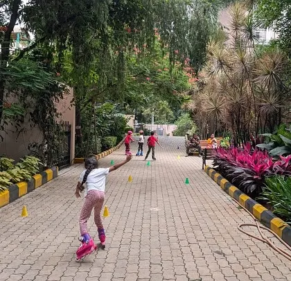 Get skating with us! A young girl practices on a paved path, showing how we use community spaces for our classes.