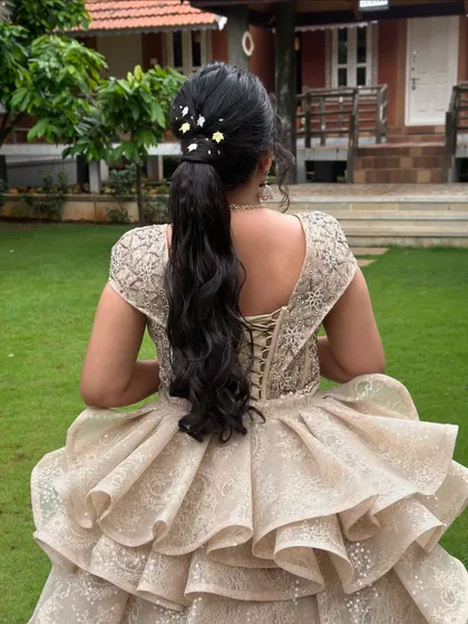 A closer look at the simple ponytail, adorned with a few delicate floral clips. It's a perfect example of how less can be more.