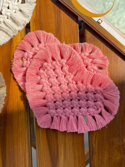 A detailed shot of the pink macrame heart coasters. We can create these in any color to match your existing home decor.