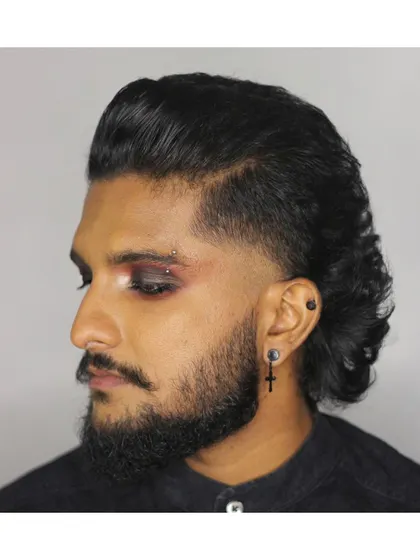 Another look from our Goth'em City project. This style features a modern mullet with a temple fade, paired with dramatic eye makeup and piercings.