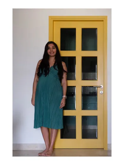 A personal photo of me standing by the yellow kitchen door I designed. This was from the handover of the 'Earthy Chic Bachelorette Pad' when I was nine months pregnant.