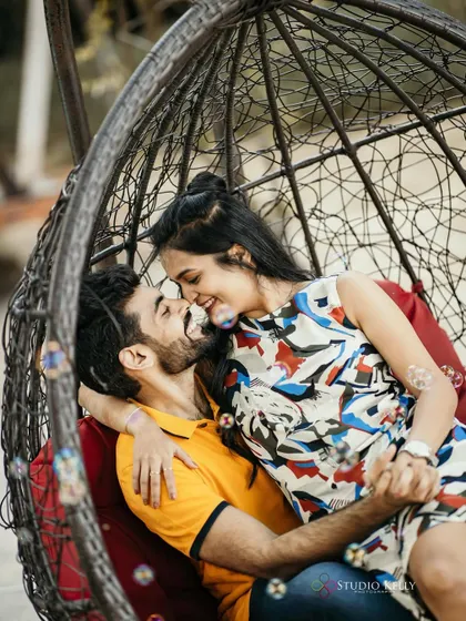 Bubbles add a touch of whimsy to this romantic shot. The makeup is light and pretty, enhancing her natural charm.