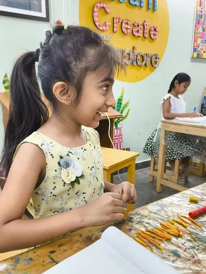 The happy, focused energy of our studio is contagious. This student is smiling as she works on her project, surrounded by the creative buzz of the classroom.