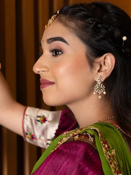 A side profile showing the elegant hairstyle and the way the makeup enhances her features without being overpowering.