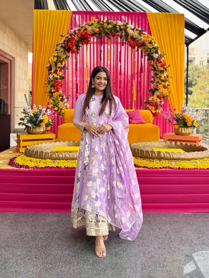 A full-length view of the lilac Anarkali, showing the palazzo pants underneath and the beautiful drape of the dupatta.