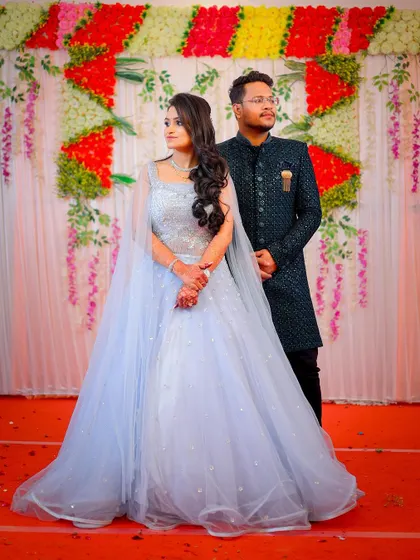 A full-length portrait of the couple in their beautiful engagement outfits.