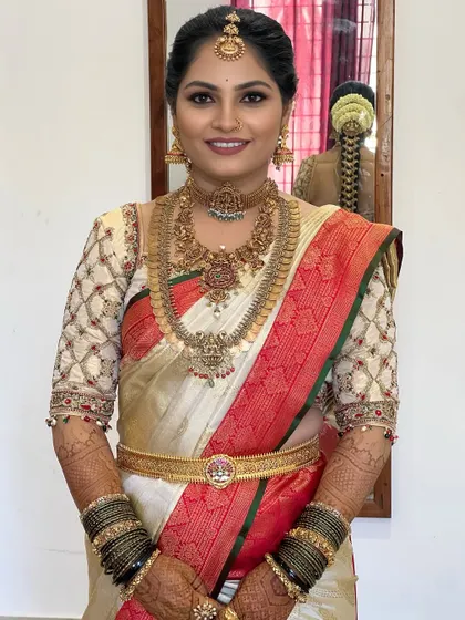 Mastering color theory is crucial. In my course, you will learn to work with a variety of bridal palettes, like this classic white and red Kanjeevaram look, ensuring the makeup harmonizes perfectly with the bride's attire.