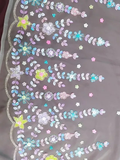 This is a close-up of the detailed handwork I love to create. Instead of traditional gold or silver, I used a palette of colorful sequins and beads to craft this floral pattern, adding a unique and modern touch to the final garment.