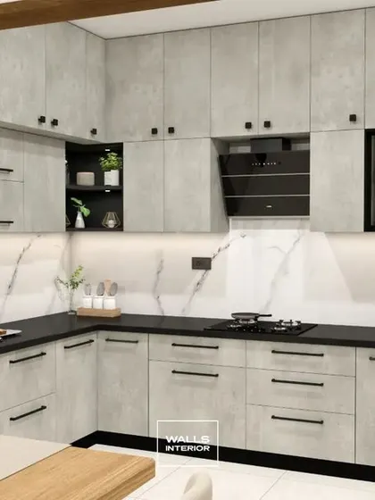 A full view of an L-shaped kitchen with grey cement-textured laminate cabinets and a contrasting black countertop. The white marble-patterned backsplash adds a touch of brightness and luxury.