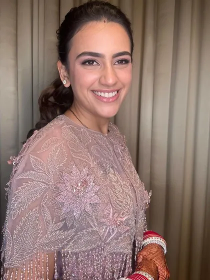 A lovely, fresh-faced look for a post-wedding event. The makeup is minimal and clean, perfect for a daytime reception.