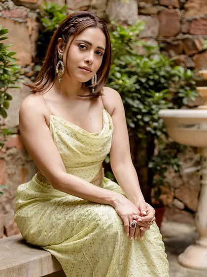 A seated portrait of Nushrratt in this beautiful Punit Balana creation. The cowl-neck top and draped skirt are effortlessly chic.