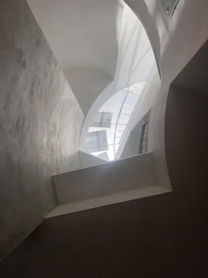 Another perspective of the sculptural skylight, showing the interplay of curved and straight lines that define the opening to the sky.