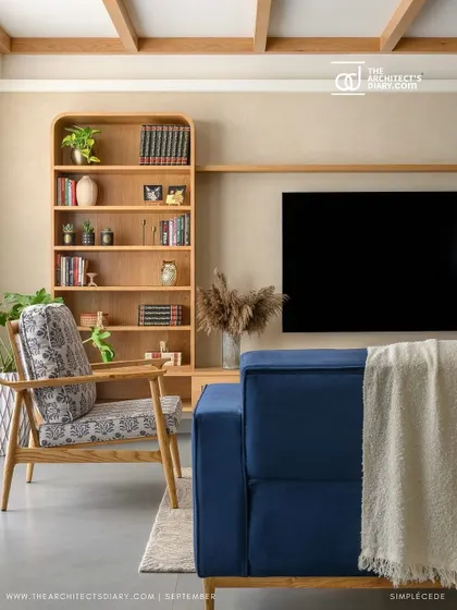 The living room of 'Cover me in Sunshine', as featured in The Architect's Diary. The blend of the blue sofa, wooden furniture, and beige textured walls was noted for its earthy elegance.