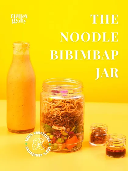 This is the complete Noodle Bibimbap Jar kit. It includes the main jar with layered veggies and noodles, a bottle of my creamy coconut soup for the base, and two mini jars of house-made chili oil and minced garlic paste for you to customize the spice.