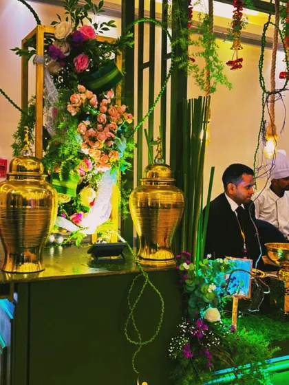 Details matter in my themed setups. Here, large golden urns and carefully placed floral arrangements complement the overall green and gold aesthetic, adding to the luxurious feel.