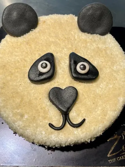 A simple and cute panda face cake. This design uses a textured crumb coating and fondant details to create an adorable animal cake.