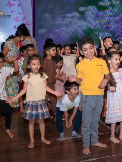 Children dance with abandon on stage, a moment of pure, uninhibited joy.