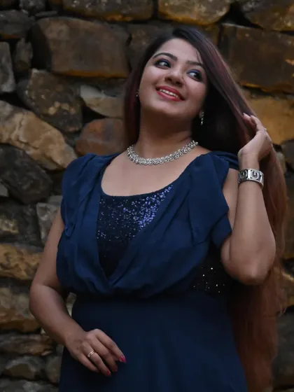 A happy and radiant shot in my twilight-blue gown. My expressions and body language are as much a part of my performance as my voice.