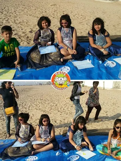 A group of young artists enjoying the sun and sand while creating their masterpieces. An outdoor art session is a great way to connect with nature and creativity.