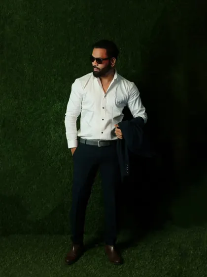A smart-casual look with a crisp white shirt and formal trousers. This versatile style works for a wide range of semi-formal events.