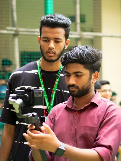 A moment of intense focus while operating a camera on a gimbal. Capturing smooth video requires concentration and a steady hand.
