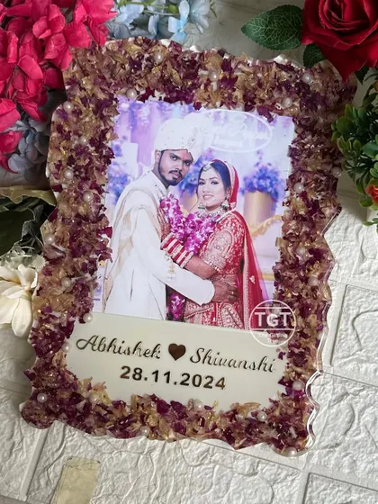 The zigzag edge of this frame adds a modern touch to the traditional preservation of wedding flowers. The purple and gold tones create a rich, royal look.