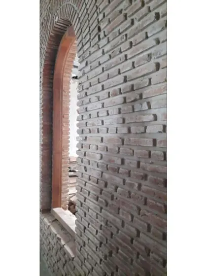 We believe in fearlessly overlapping old and new. In this project, we preserved the original 'acchukal' (brick) wall and arch from the existing building, adding drama and history to the new home.