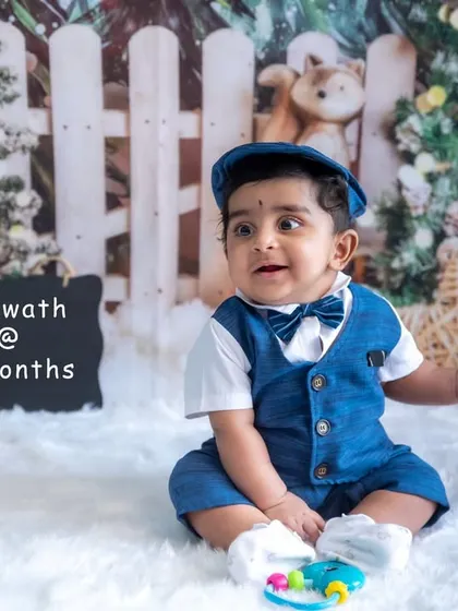 This 7-month-old sitter is looking sharp in his little suit. Our studio milestone sessions are a great way to document your baby's growth.