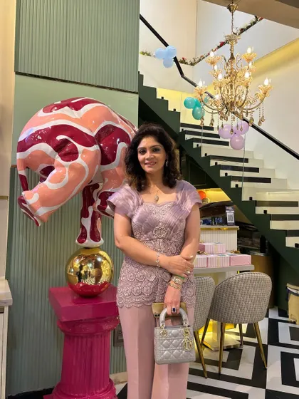 A guest poses in our beautifully designed space, highlighting the venue's elegant decor.