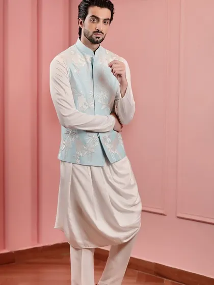 This pose highlights the elegant drape of the kurta beneath the structured Nehru jacket, a perfect balance of softness and tailoring.