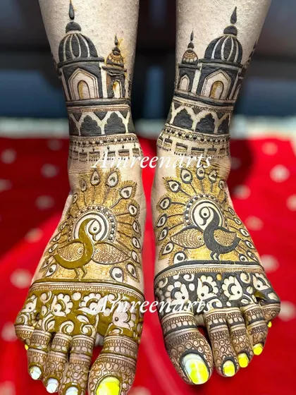A bold and royal foot design, with large peacocks spreading their feathers under majestic palace domes.