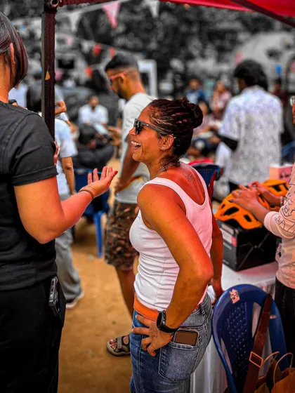 A candid shot of attendees enjoying the social atmosphere and browsing the stalls at the Garage Sale.