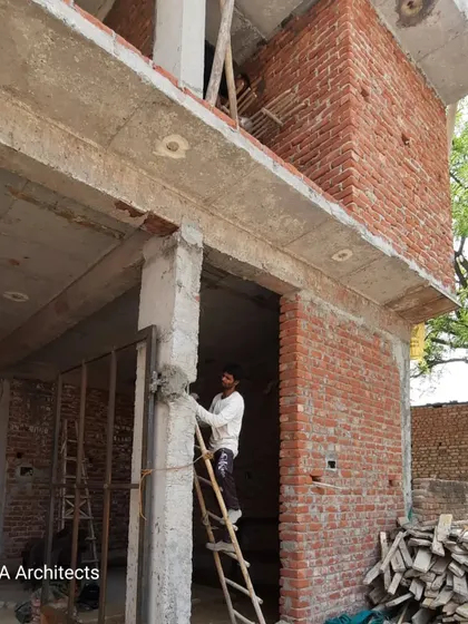 An on-site image capturing the foundational stages of construction. This view shows the exposed brickwork and concrete structure, the essential skeleton of the future building.