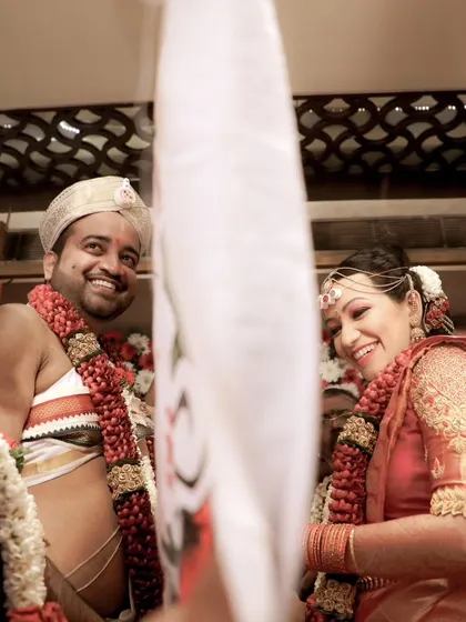 A beautiful, candid moment of laughter between the bride and groom during their wedding ceremony.