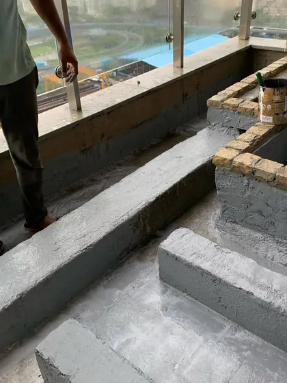 Applying a final layer of waterproofing coat to the custom-built planters and channels on a terrace to prevent any leakage.