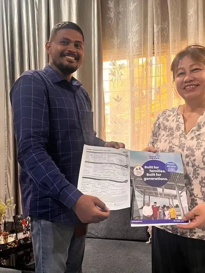 A customer receives her solar agreement and booklet from our team member.