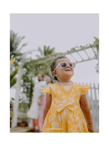A cute candid of a little guest enjoying the festivities in her sunglasses.