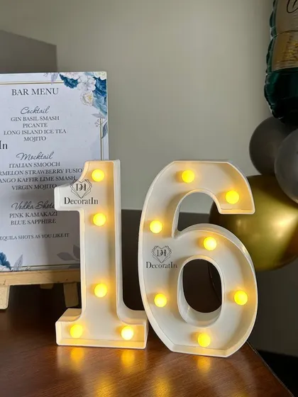 The bar menu for the 16th birthday, accompanied by a small marquee '16'.