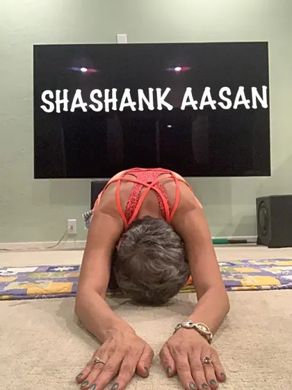 Shashank Asan, a variation of Child's Pose, offers a deep release for the entire back. It's a grounding posture that encourages introspection and calm.