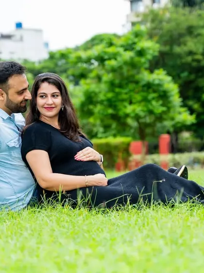 A relaxed and happy moment for an expecting couple, sitting together on the grass. This shows that maternity photos can be casual, comfortable, and still incredibly beautiful.