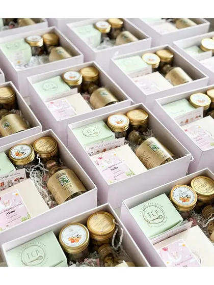 Getting a large order of baby announcement hampers ready. Each box is filled with a dense chocolate cake, oat coconut cookie bites, granola, and more.