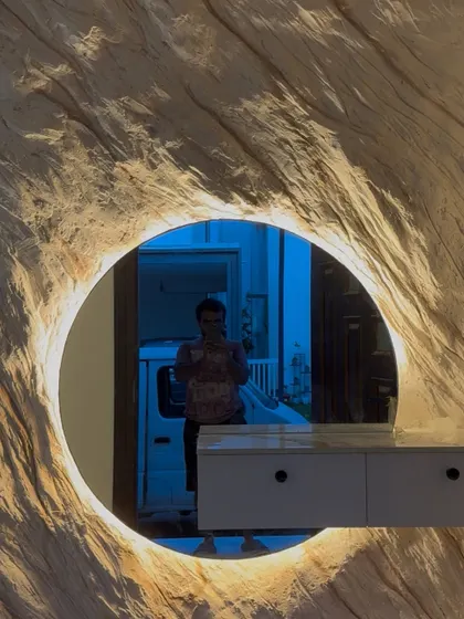 Where texture meets timelessness. This relief art mural brings the raw elegance of natural rock formations right into the foyer, sculpted around a backlit mirror to create a functional and stunning entryway feature.